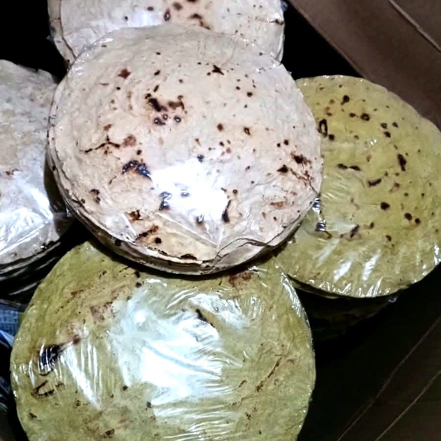 Fresh jowar and bajra rotis, packed in stacks ready for delivery